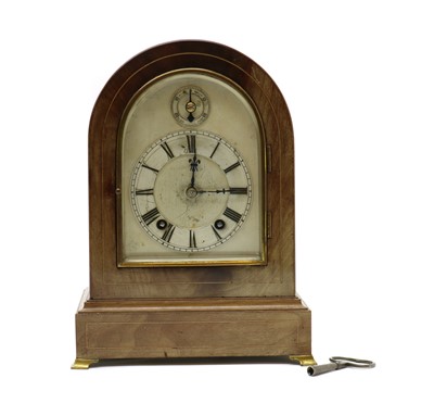 Lot 207 - A mahogany and curved glass mantel clock