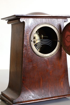 Lot 115 - An Art Nouveau oak mantel clock