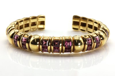 Lot 184 - A gold pink topaz sprung torque bangle