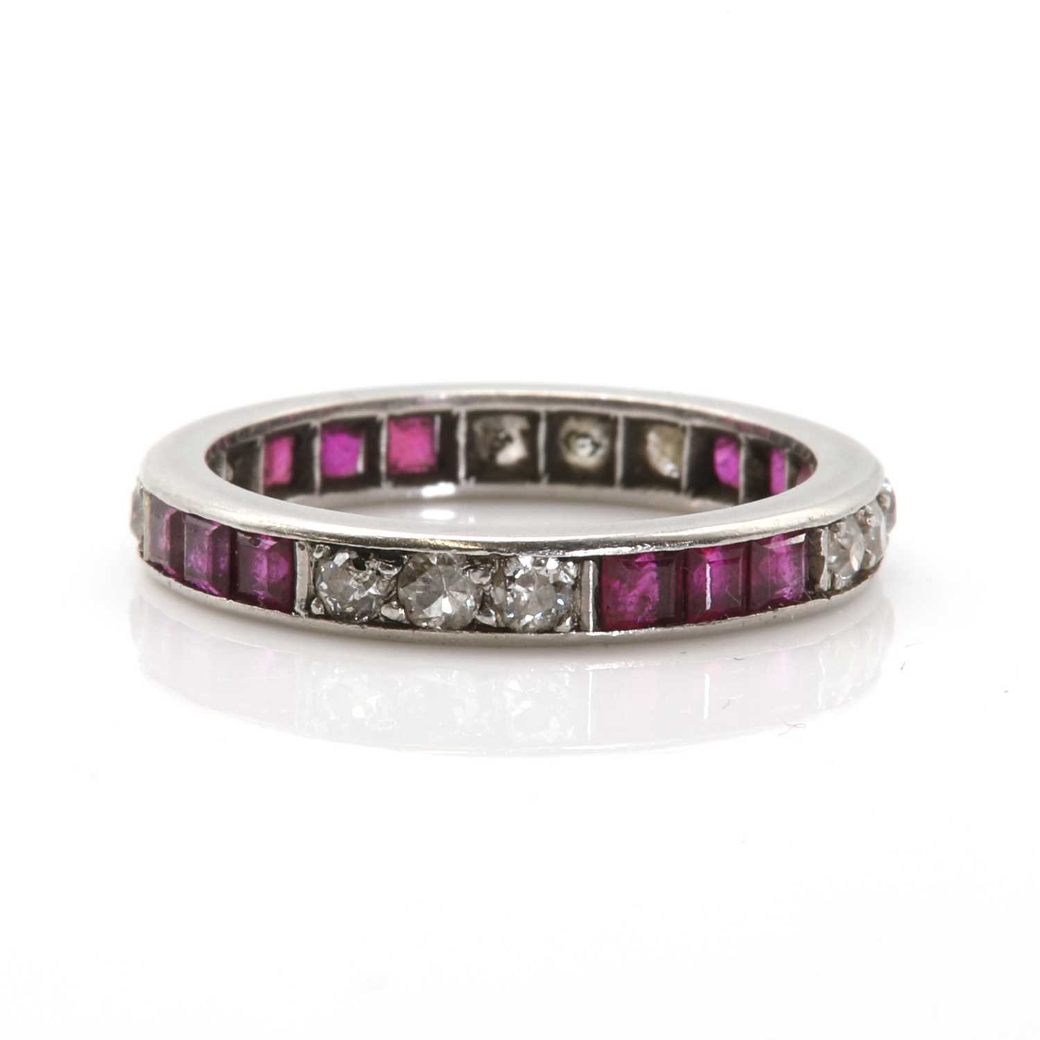 Lot 64 - A platinum ruby and diamond eternity ring