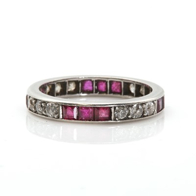 Lot 64 - A platinum ruby and diamond eternity ring