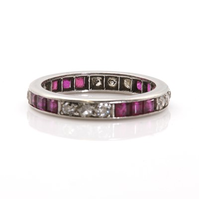 Lot 64 - A platinum ruby and diamond eternity ring