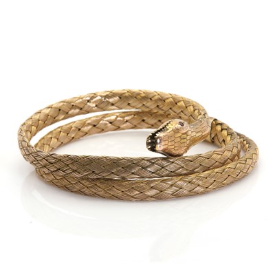 Lot 31 - A gold coiled snake flexible bangle