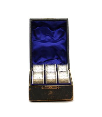 Lot 28 - A set of six cased silver napkin rings