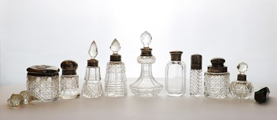 Lot 45 - A collection of silver-mounted cut glass dressing table bottles