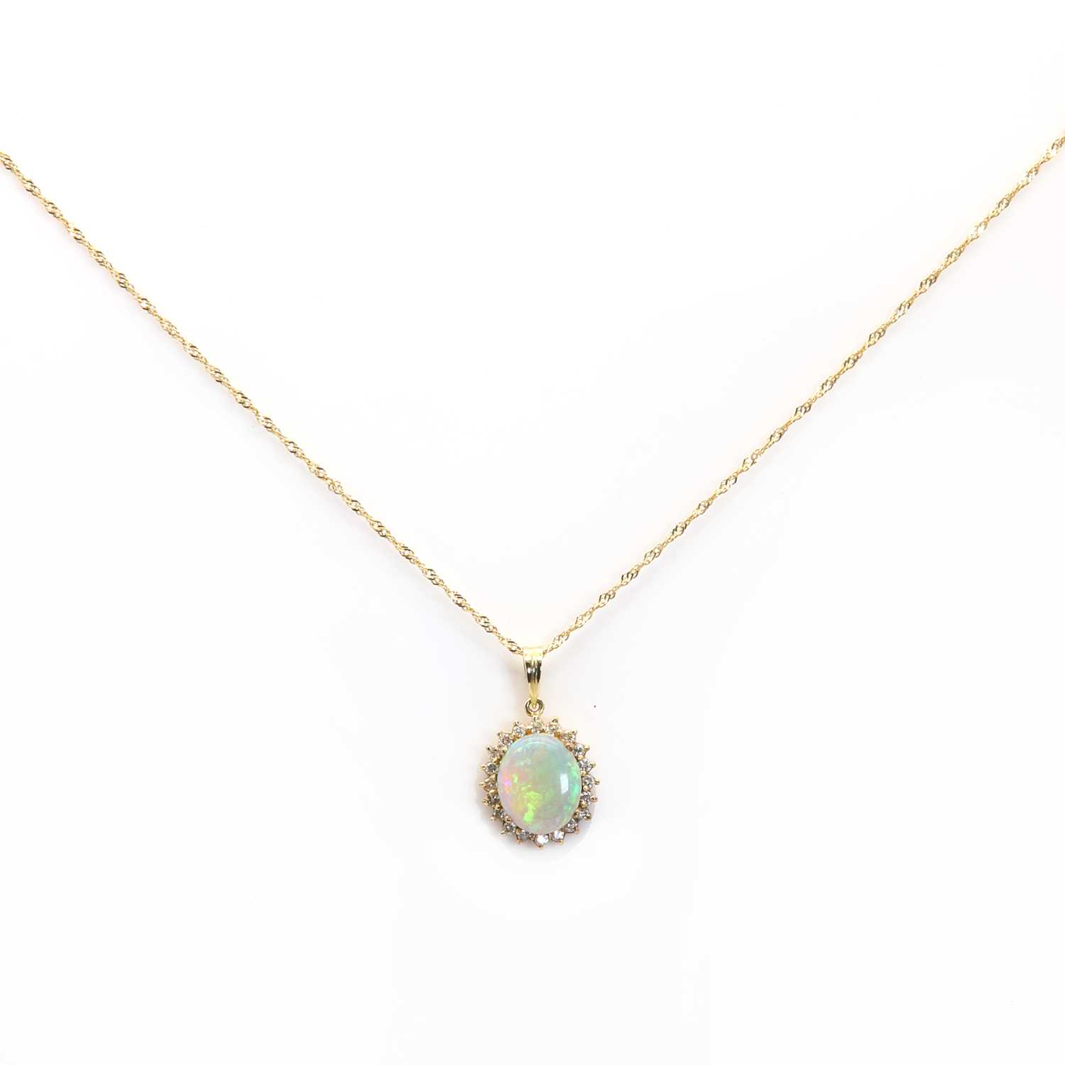 Lot 182 - An opal and diamond oval cluster pendant