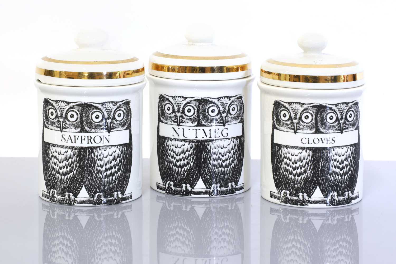 Lot 318 - An Italian Fornasetti group of three porcelain owl storage jars or canisters