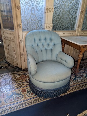 Lot 15 - A button-upholstered spoon-back armchair