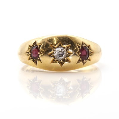 Lot 47 - An 18ct gold diamond and garnet three stone ring