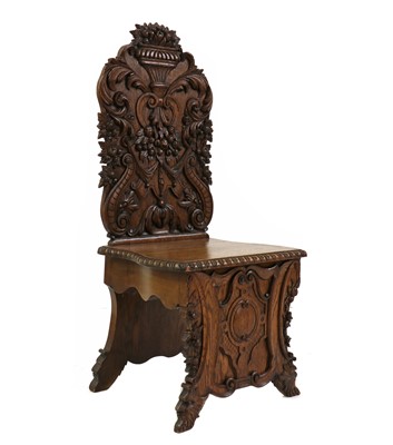 Lot 416 - A carved oak hall chair
