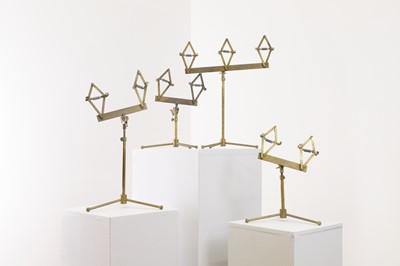 Lot 510 - A set of four gilt-brass display stands
