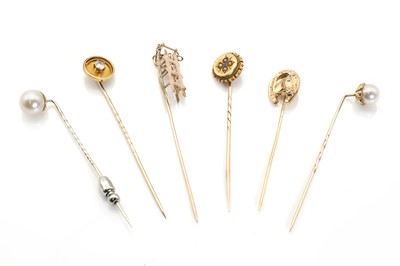 Lot 303 - A collection of six assorted gold stick pins