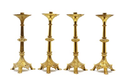 Lot 204 - A group of four brass ecclesiastical style candlesticks