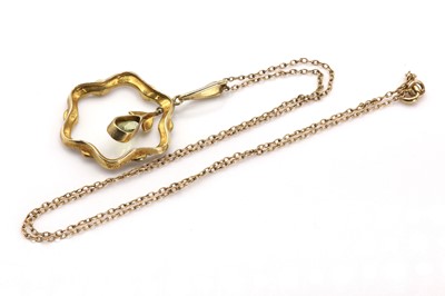 Lot 28 - An Edwardian peridot and seed pearl pendant by Murrle Bennett & Co.