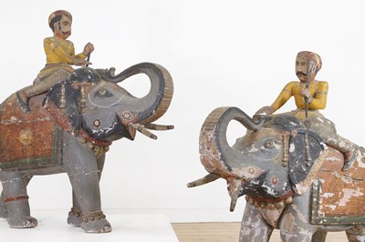 Lot 218 - A pair of Rajasthani carved and painted wooden elephants