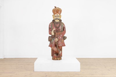 Lot 243 - A Rahjastani carved wooden figure of a man
