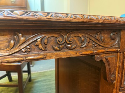 Lot 204 - A Victorian oak twin-pedestal desk in the George II taste