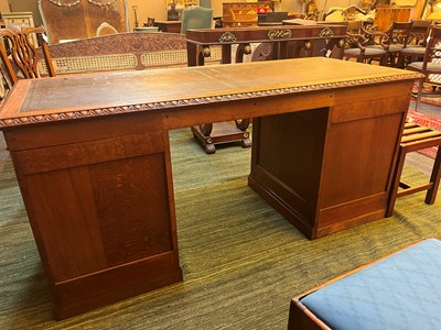 Lot 204 - A Victorian oak twin-pedestal desk in the George II taste