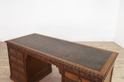 Lot 204 - A Victorian oak twin-pedestal desk in the George II taste