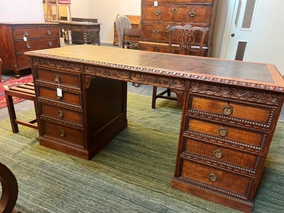 Lot 204 - A Victorian oak twin-pedestal desk in the George II taste