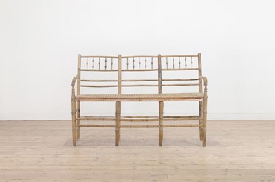 Lot 507 - A stripped pine faux bamboo settee