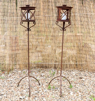 Lot 496 - A pair of iron garden candle stands