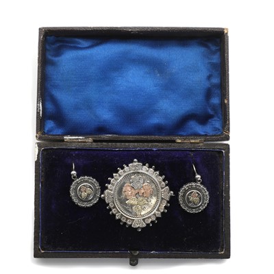 Lot 25 - A Victorian Aesthetic Movement silver brooch and earrings suite