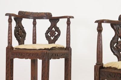 Lot 87 - A pair of George II-style carved walnut corner chairs