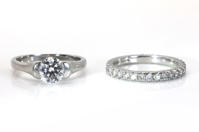 Lot 175 - A platinum single stone diamond ring and a half eternity band