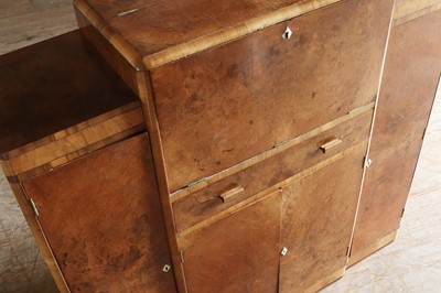 Lot 204 - An Art Deco walnut crossbanded breakfront cocktail cabinet