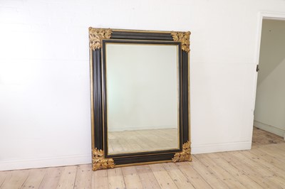Lot 364 - A large baroque-style ebonised and parcel-gilt mirror
