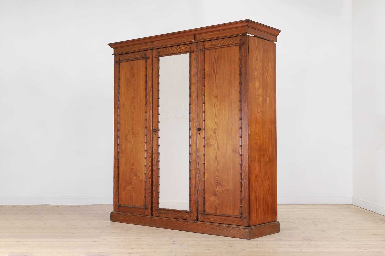 Lot 400 - A late Victorian pitch pine wardrobe by Howard & Sons