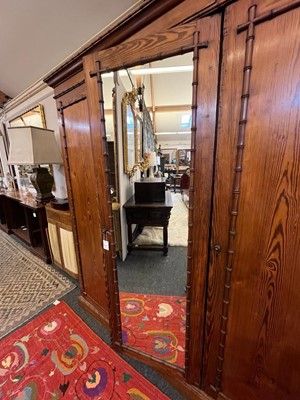 Lot 400 - A late Victorian pitch pine wardrobe by Howard & Sons