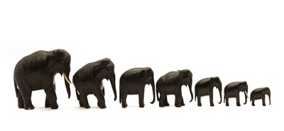Lot 233 - A group of seven carved hardwood elephants