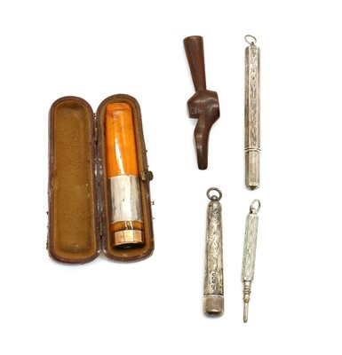 Lot 120 - A cased 9ct gold and amber cigar holder