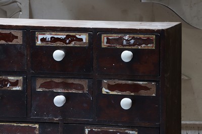 Lot 421 - ☘ A pharmacist's bank of stained pine medicine drawers