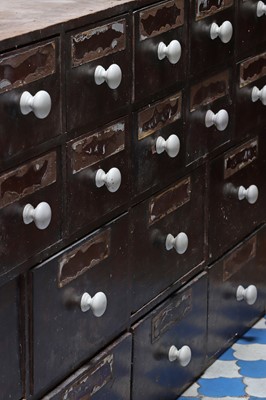 Lot 421 - ☘ A pharmacist's bank of stained pine medicine drawers