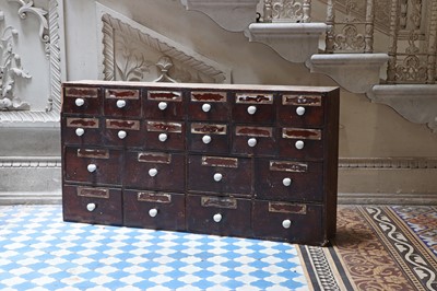 Lot 421 - ☘ A pharmacist's bank of stained pine medicine drawers