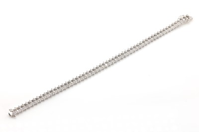 Lot 144 - An 18ct white gold diamond set twin line bracelet