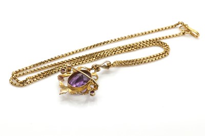 Lot 29 - An Edwardian amethyst and split pearl scrolling brooch/pendant