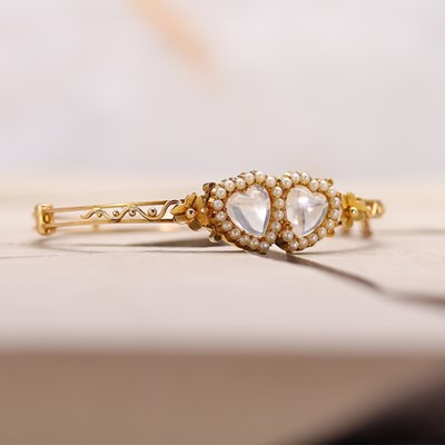 Lot 10 - A Victorian double heart moonstone and seed pearl bangle