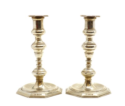 Lot 108 - A pair of cast silver candlesticks