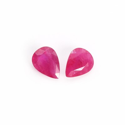 Lot 128 - A pair of loose pear cut rubies