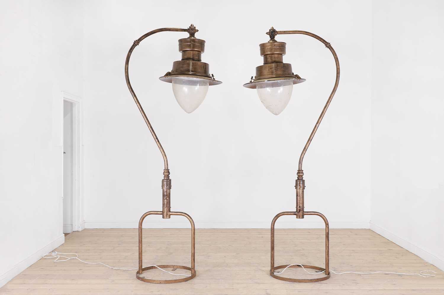 Lot 130 - A pair of large painted metal lamps