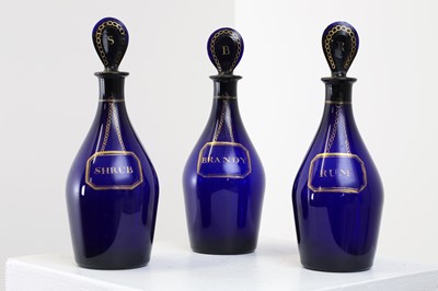 Lot 325 - A near set of five Regency Bristol blue glass decanters