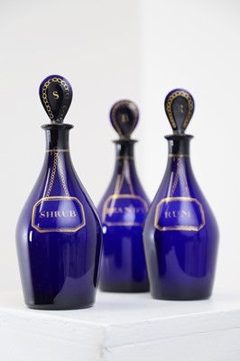 Lot 325 - A near set of five Regency Bristol blue glass decanters