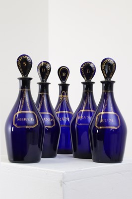 Lot 325 - A near set of five Regency Bristol blue glass decanters