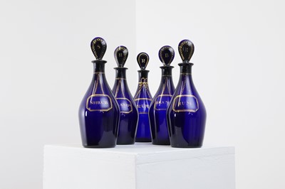 Lot 325 - A near set of five Regency Bristol blue glass decanters