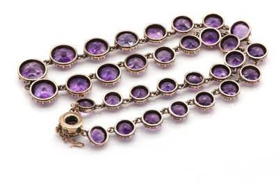 Lot 16 - A Victorian gold graduated amethyst rivière necklace