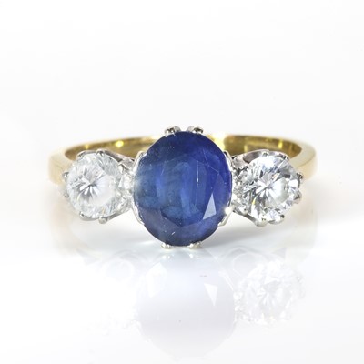 Lot 166 - An 18ct gold  three stone sapphire and diamond ring